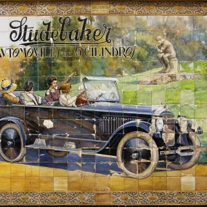 Old advertisement for a car on ornate ceramic tiles Old advertisement for a car on ornate ceramic tiles