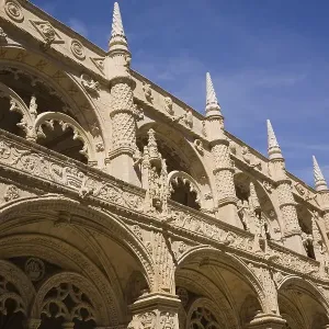 Old architectural building with arches and carved decorative sculptures in the inner courtyard at Jeronimos Monastery