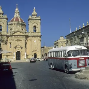 Old bus in front of the church of Nadur
