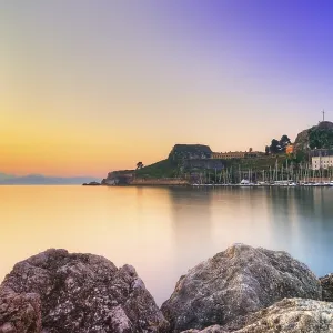 Old fortress, romantic view of a fortress at sunrise over calm water