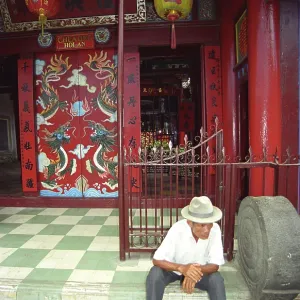 Old man on the steps of a Buddhist temple Old man on the steps of a Buddhist temple