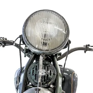 Old motorcycle, front view of light and handlebars Old motorcycle, front view of light and handlebars