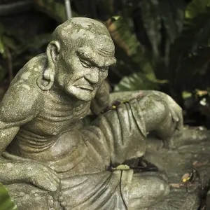 Old ruined Arhat Kanakbharadvaja statue in forest