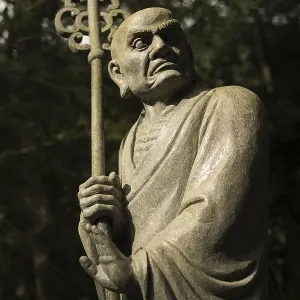 Old ruined Arhat Kanakbharadvaja statue in forest
