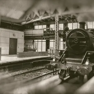Old steam train, vintage locomotive entering train station Old steam train, vintage locomotive entering train station