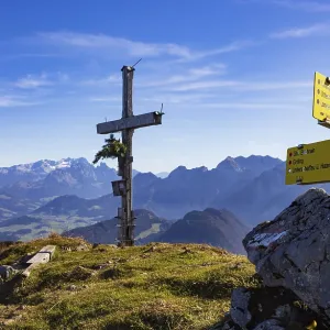 Old summit cross on the Schwarzer Berg with a view of the Dachstein massif Old summit cross on the Schwarzer Berg with a view of the Dachstein massif