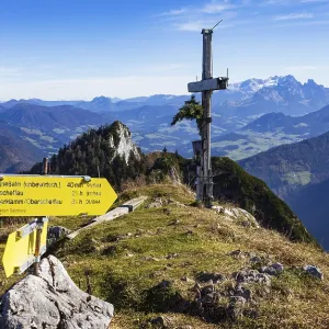 Old summit cross on the Schwarzer Berg with a view of the Dachstein massif Old summit cross on the Schwarzer Berg with a view of the Dachstein massif