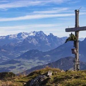 Old summit cross on the Schwarzer Berg with a view of the Lammertal valley and Dachstein massif
