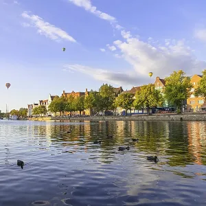 The Old Town of Lubeck, Germany with ducks in the river and balloons in the sky