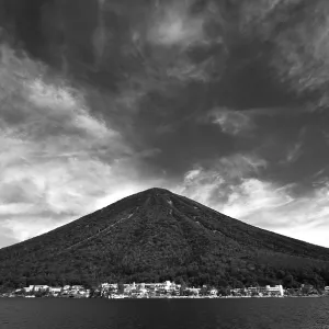 Old volcano mountain over the lake waters
