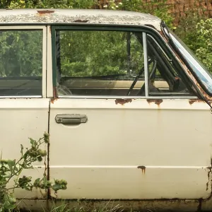 Old weathered abandoned neglected rusty broken vintage obsolete car closeup in rural place Old weathered abandoned neglected rusty broken vintage obsolete car closeup in rural place