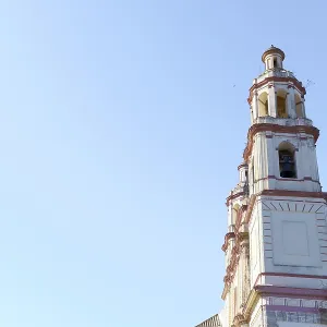 Olvera church bell tower rising against a clear blue sky in olvera Olvera church bell tower rising against a clear blue sky in olvera