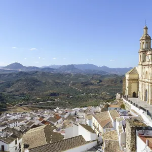 Olvera town perched on a hill, featuring its historic church and white houses Olvera town perched on a hill, featuring its historic church and white houses