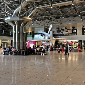 Open airport space with people and architectural details