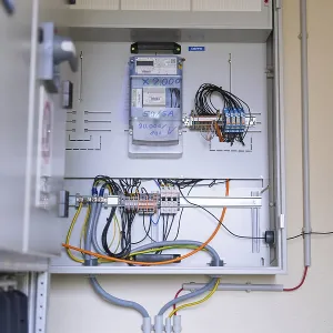 Open electrical box with numerous wires and technical equipment