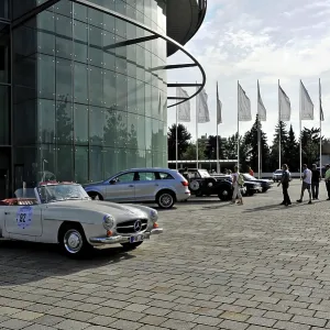 Open space in front of a modern building with a parked vintage car Open space in front of a modern building with a parked vintage car