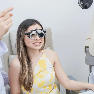 Optometry eye health concept. Optometrist assisting patient with optometrist trial frame