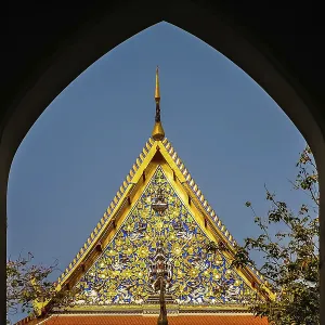 Ornate golden triangular roof of a Buddhist temple in Bangkok Ornate golden triangular roof of a Buddhist temple in Bangkok