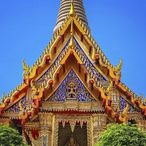 Ornate golden triangular roof of a Buddhist temple in Bangkok Ornate golden triangular roof of a Buddhist temple in Bangkok