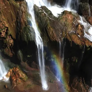 Ouzoud waterfalls with an impressive rainbow over the bubbling waters