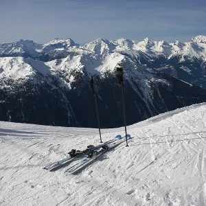 Pair of mountain skis against a mountain landscape