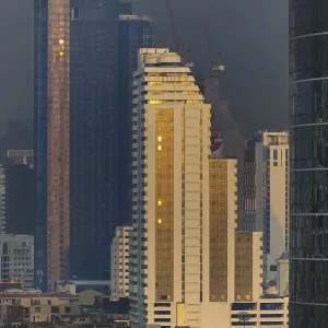 Panorama from the Iconsiam viewing platform of skyscrapers of the Bangrak banking district at sunset