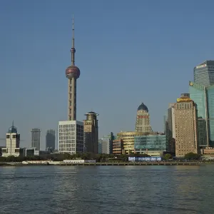 Panorama of a modern skyline of Huangpu Jiang with television tower and water in the foreground