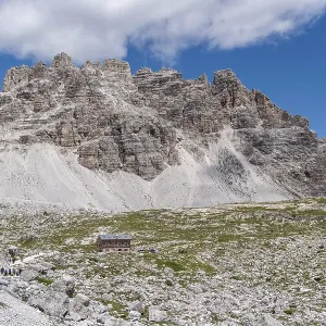 Panoramic trail in front of the mighty rock faces of the Dolomites