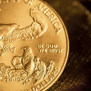 Partial view of an American gold coin highlighting the eagle and engravings