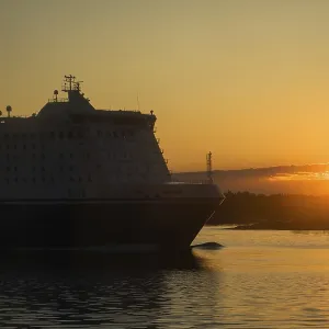 Passenger and freight ferry against a sunset in the Baltic sea
