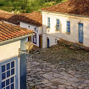 Paving stones made by slaves on the streets with colonial-style houses in the city of Tiradentes built in the 18th Paving stones made by slaves on the streets with colonial-style houses in the city of Tiradentes built in the 18th