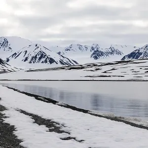 Pebble beach in a bay, mountain range