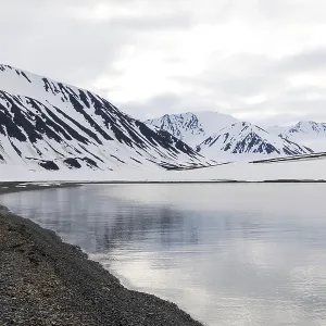 Pebble beach in a bay, mountain range