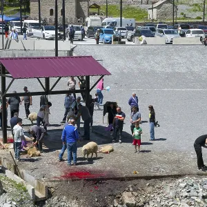 People gather around a slaughter site