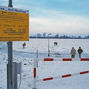 People walk across ice rink, ferry dock