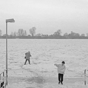 People walk across ice rink, ferry dock