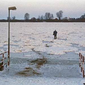People walk across ice rink, ferry dock