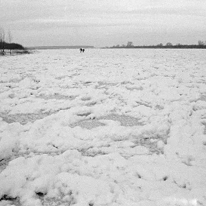 People walk across ice rink, frozen Elbe
