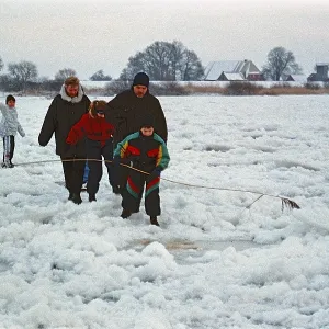 People walking across ice rink