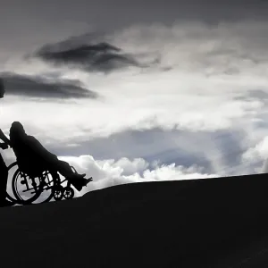 Person pushing a wheelchair, care for the elderly