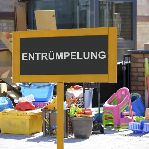 (Photomontage) Sign with the inscription ENTRUMPELUNG vor Sperrmull at a residential building<br> (Photomontage)