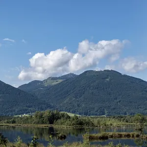 Picturesque moorland landscape with mountains under a blue sky and white clouds Picturesque moorland landscape with mountains under a blue sky and white clouds