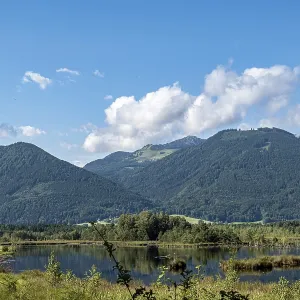 Picturesque moorland landscape with mountains under a blue sky and white clouds Picturesque moorland landscape with mountains under a blue sky and white clouds