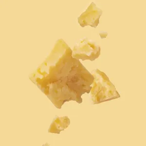 Pieces of cheese on a yellow background