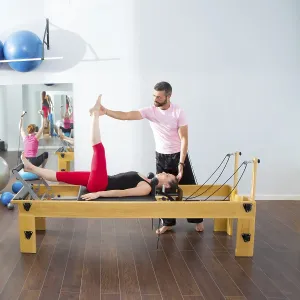 Pilates aerobic personal trainer instructor man in cadillac fitness woman exercise Pilates aerobic personal trainer instructor man in cadillac fitness woman exercise