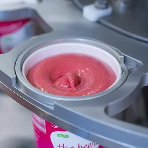 Pink raspberry ice cream is filled into a vegan sundae