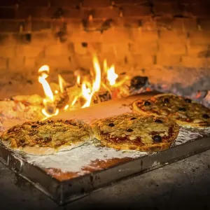 Pizza is baked in a pizza oven Pizza is baked in a pizza oven