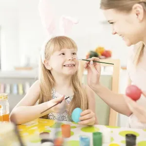 Playful woman with daughter preparing easter