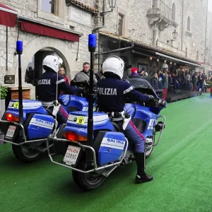 Police motorcycles escort a classic car rally through the stone old town Police motorcycles escort a classic car rally through the stone old town