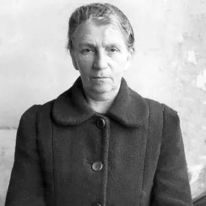 Poor, elderly woman in coat, post-war period Poor, elderly woman in coat, post-war period